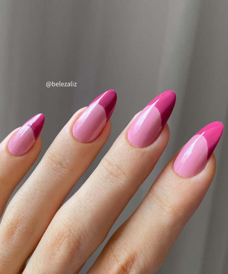 A imagem retrata nail art. Os esmaltes usados são de cor: rosa e magenta. O esmalte está uniforme e brilhante. 
