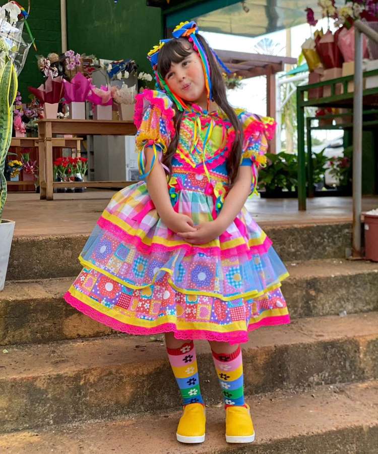 Menina com vestido colorido para festa junina infantil