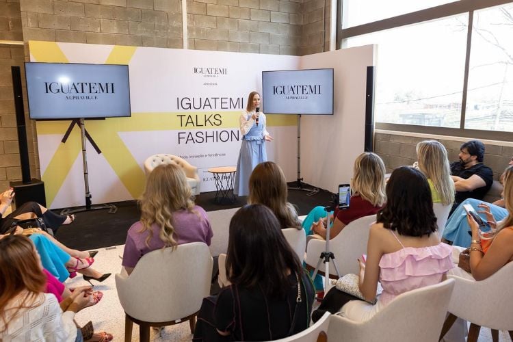 Luana Marinosse palestrando no Iguatemi Talks Fashion, com plateia sentada 