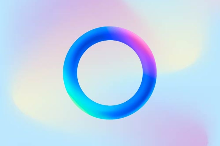 A imagem apresenta a logo da IA do WhatsApp, composta por um anel colorido em tons gradientes de azul, rosa e roxo, simbolizando tecnologia e inovação. O fundo é suave, com nuances de azul e rosa, criando um efeito etéreo e moderno. O design é simples, mas visualmente impactante, refletindo a identidade tecnológica da marca.