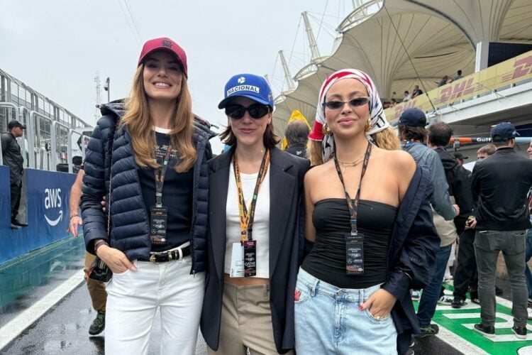 Foto de Camila Queiroz usando look azul marinho e branco, Alice Wegmann usando look com cores neutras e Julia Rodrigues usando look preto e jeans abraçadas